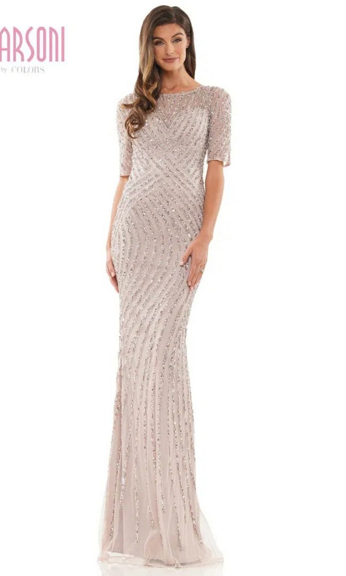 A woman in a dusty rose Marsoni MV1209 long formal dress with short sleeves and sequin embellishments stands against a plain white background.